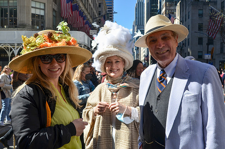 A group of people are seen dressed up with floral hats at the annual Easter Parade on April 17, 2022 in New York City. Each year New Yorkers put on their most creative hats and outfits and stroll down Manhattan's Fifth Avenue on Easter Sunday.