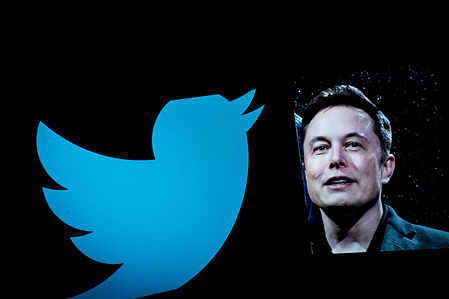 In this photo illustration, Elon Musk is seen displayed on a smartphone with a background of the Twitter logo. after Elon Musk's $44 billion acquisition of social media platform Twitter.