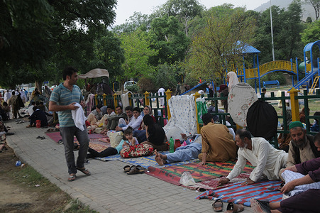 Afghan refugees seeking asylum abroad gather at an open field in protest to demand help from the United Nations High Commissioner for Refugees (UNHCR) in Islamabad.