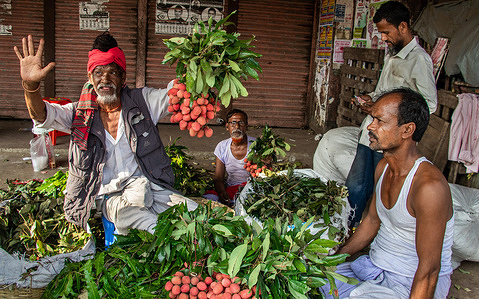 Lichi is a fruit that is very popular in Bangladesh. Vendors are selling lichi on the street.