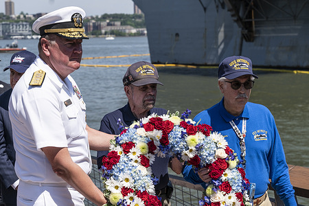 Rear Admiral Charles Rock (L) and veterans of Intrepid throw a wreath into the Hudson River during the Intrepid Sea, Air & Space Museum annual Memorial Day Commemoration Ceremony