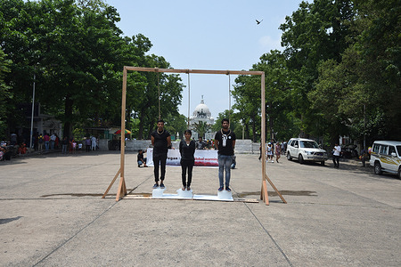 The vegan activists stand on ice blocks with ropes hanging around their neck to symbolize the catastrophic climate crisis and its devastating impact on humankind on the entire planet for awareness on the World Environment Day before the iconic Victoria Memorial Hall in Kolkata.