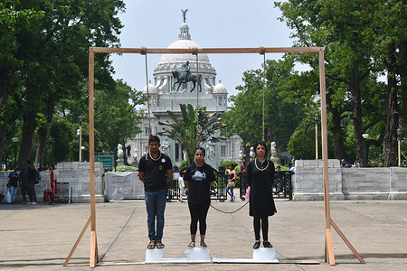 On the occasion of world environment day, members of Vegans of Bengal are standing on melting ice and putting a noose on their necks, for their demonstration theme "The Planet in a Noose" in Kolkata.