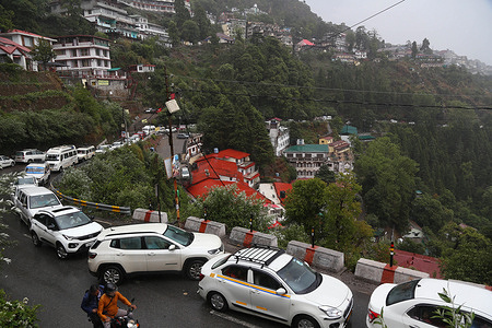 Vehicles moving slowly in a traffic jam during the first rain of monsoon in Mussoorie. Tourists from across the country arrives here to celebrate weekend in summer season.