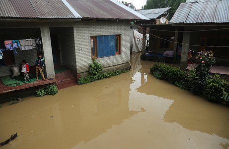 Flood water flows through the residential area after incessant rainfall in Pattan north of Srinagar, Kashmir. Heavy rains have been lashing parts of region for the past few days, triggering flash floods and landslides and leading to closure of strategic Jammu-Srinagar national highway.In many areas, the schools were closed as a precautionary measure.The Meteorological office has warned people to avoid going or working near sloppy Nallas as flash flood often occurs suddenly.