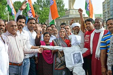Congress activists burnt an effigy with the picture of Indian Prime Minister Narendra Modi and Home Minister Amit Shah during a protest against the Agnipath scheme and the Enforcement Directorate (ED) summoning of its former chief Rahul Gandhi, at Mahtama Gandhi Circle in Beawar.