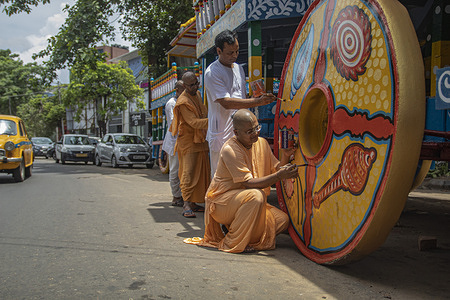 Lord Jagannath Ratha Yatra or Chariot Festival in Kolkata organized by ISKON. The chariot making work of Lord Jagannath, Lord Balabhadra and Mata Subhadra for upcoming festival is going on. A Muslim painter is painting for the Hindu God's chariot.