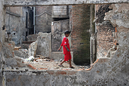 Children play in the rubble of a building that was left by a residential fire at the former location of the fire in the Kampung Pasar Gembrong area, East Jakarta, Indonesia. The Provincial Government of the Special Capital City Region of Jakarta has begun revitalizing residential areas in the former location of the fire in the Pasar Gembrong Village, East Jakarta, Indonesia. The Pasar Gembrong Village, which is called Kampung Gembira Gembrong, has a total of 136 buildings. These will later be built on an area of 1,200 square meters, which costs 7.8 billion rupiahs and is targeted for completion in September 2022. This revitalization will be able to present a new face and give a new name for the residence that will bring comfort to residents.