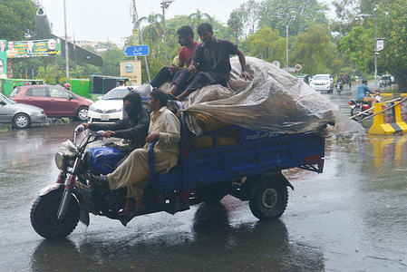 Pakistani people are struggle to move forward on mall road during heavy monsoon rain in Provincial Capital city Lahore.