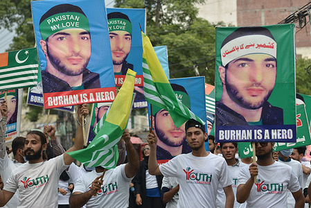 Pakistani activists of Youth Forum for Kashmir hold placards featuring images of slain Indian Kashmiri rebel leader Burhan Muzaffar Wani and to express solidarity with Kashmiris who are resisting Indian rule during a rally for the leader sixth death anniversary in Lahore. Indian authorities imposed restrictions of movement around the Jamia Masjid mosque in Srinagar on July 8 during a strike called by Kashmiri seperatists on the sixth anniversary of the death of commander Burhan Muzaffar Wani.