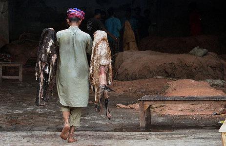 Pakistani workers collect sacrificial animal skins with salt after the cleaning and preserving process at their workplace in Lahore. For further transportation to different factories, the core products are leather garments, gloves, tanned leather, and footwear.