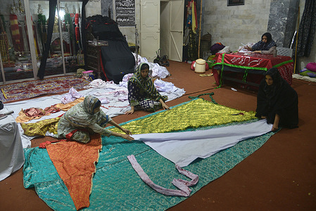Pakistani shiite women busy in making Tazia Azadari items at Azakhana Pando street Islam Pura for the 9th Muharram ul-haram procession during Holy month of Muharram-ul-Haram in Lahore. Women are busy making stuff for the horse (Zuljinnah that represents carrying Imam Hussein in a 680 A.D. battle), These are being preparing for mourning rituals during the month of Muharram-ul-Haram which is the first month of the Islamic calendar and second holiest month for Muslims across the world.