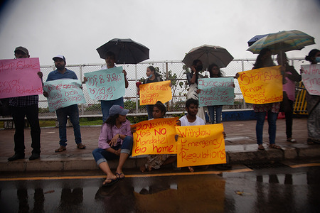 Satyagraha at the barricade: Women Activist join in on the silent protest and some sit on the pavement by the police barricade amidst heavy rainfall.