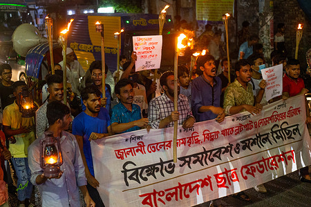 Activists hold a rally and torch procession to protest against fuel price hike and load shedding in Dhaka.