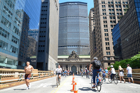 New Yorkers are seen walking and biking around Park Avenue during car free “Summer Streets” along Park Avenue in New York City.