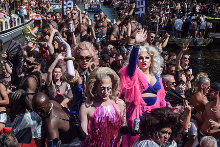 Participants dance on boats and wave to onlookers during the Canal Parade. The Amsterdam Pride was on hold for 3 years due to the COVID-19 pandemic restrictions.