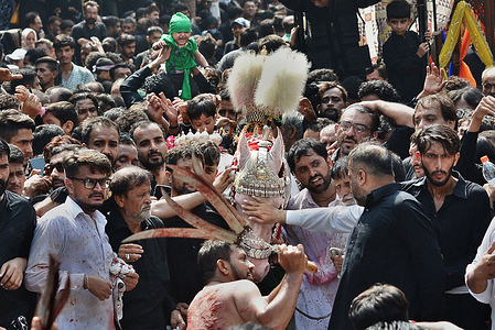 Pakistani Shiite Muslim mourners self-flagellate during a Muharram procession on the ninth day of Ashura in Lahore. Muharram, the first month of the Islamic calendar, is a month of mourning for Shiites in remembrance. Ashura is a period of mourning in remembrance of the seventh-century martyrdom of Prophet Mohammad's grandson Imam Hussein, who was killed in the battle of Karbala in modern-day Iraq, in 680 AD.