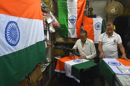 MD Arif, 65, a tailor builds Indian national flags before the 75th Independence Day celebrations in his shop in Kolkata.