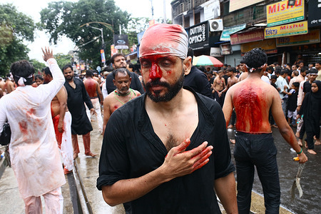 Shiite Muslim mourners flagellate themselves on the tenth day of Ashura during the Islamic month of Muharram, commemorating the seventh century killing of Prophet Mohammed's grandson Imam Hussein in Kolkata.
Shi'ite Muslim mourners flagellate themselves during a Muharram procession to mark Ashura in Kolkata on August 09, 2022. After a gap of two years due to COVID-19 related restrictions, this year the mourners were permitted to organise processions in the city.