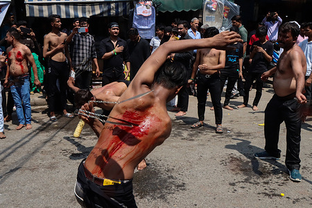 (EDITORS NOTE: Image contains graphic content) Shi'ite Muslim men flagellate themselves during a congregation to mark Ashura, the tenth day of Muharram. Muharram commemorates the death of Prophet Muhammad's grandson, Hussein Ibn Ali. Hussein was murdered during the battle of Karbala, which took place on the day of Ashura in the year AD 680.