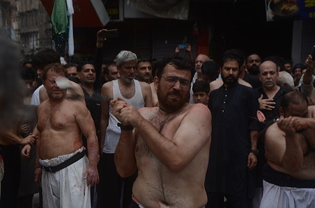 Shiite Muslims flagellate themselves with knifes on chains during a procession to mark Ashoura in Peshawar. Ashoura falls on the 10th day of Muharram, the first month of the Islamic calendar, when Shiites mark the death of Hussein, the grandson of the Prophet Muhammad, at the Battle of Karbala in present-day Iraq in the 7th century.