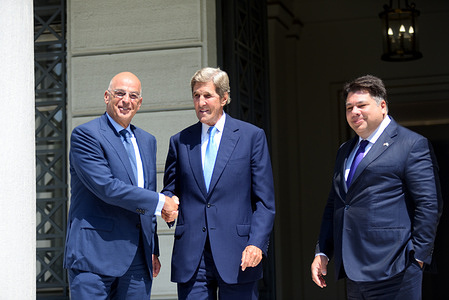 Handshake of Greek Minister of Foreign Affairs Nikos Dendias (left) with US President's Special Envoy for Climate and former Foreign Minister, John Kerry (right) in the presence of ambassador of USA George J. Tsunis in Athens, Greece.