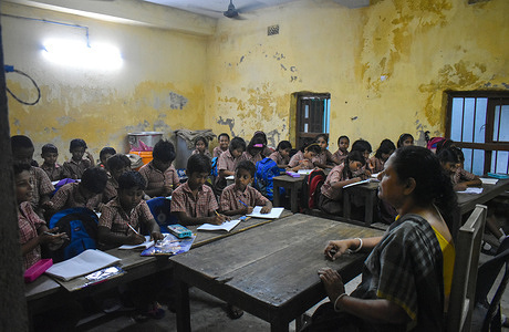 Students are attending their class inside a classroom in a Government Primary school on the outskirts of Kolkata.