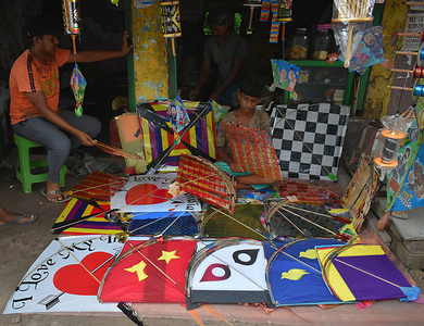 A boy is selling kites ahead of Biswa karma puja on the outskirts of Kolkata.
