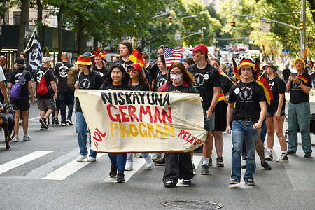 NIskayum German Program students are seen marching with German flags on Fifth Ave in New York City during the annual Steuben Day Parade.