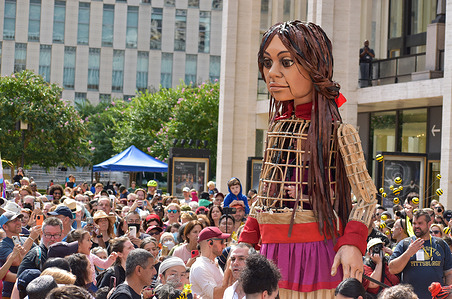 A giant puppet depicting a Syrian refugee girl called “Little Amal”, walks on Lincoln Center Plaza, as part of the international art project The Walk. - 'Little Amal' was designed by The Handspring Puppet Company and represents a Syrian refugee child and the millions of displaced children worldwide.