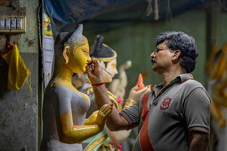 Clay artisan does some finishing touches on Durga idol in preparation for the upcoming Durga Puja festival. Bengal specializes in preserving the age old tradition of making clay idols. Such unmatched skills come in the limelight during the festive occasion of Durga Puja.