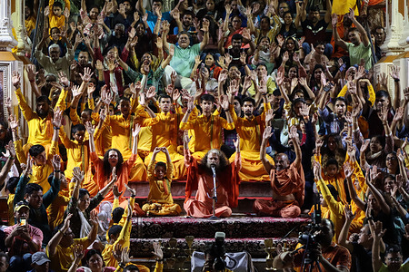 Pujya Swami Chidanand Saraswati also called Pujya Swamiji or Pujya Muniji by disciples, the President and Spiritual Head of Parmarth Niketan Ashram along with devotees perform daily ritual of offering prayers to the Ganges river.  
Parmarth Niketan founded in 1942 by Pujya Swami Sukhdevanandji Maharaj is the largest Ashram in Rishikesh, with over 1000 rooms providing clean, pure and sacred atmosphere with abundant, beautiful gardens to thousands of pilgrims who come from all corners of the Earth. 
The daily activities at Parmarth Niketan include daily yoga specialising in Vinyasa Yoga, general Hatha yoga, and yoga Nindra, morning universal prayers and meditation classes, daily satsang and lecture programs, kirtan and daily Ganga Aarti at sunset, attended by hundreds of devotees and visitors each day at the shore of Ganges.
