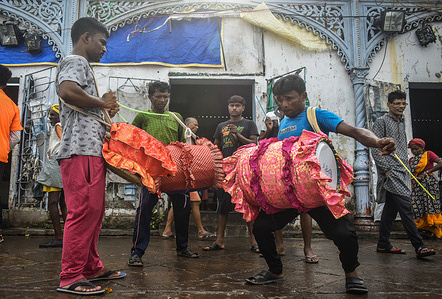 Men beat the traditional Indian drums called "Tasha" on the occasion of the festival of Durga Puja in Kolkata.