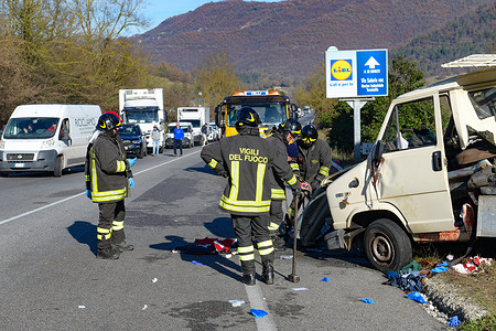 Firefighters remove the sheet metal from the accident on State Road 4 for Rome, in Rieti in Italy on 20 December 2022.