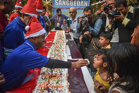 A group of special children make a 50 feet cake and distribute the cake to the street children on the occasion of Christmas in Kolkata.