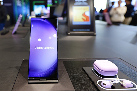 The Galaxy S23 Ultra, the newest smartphone by Samsung, and the Galaxy Buds 2 Pro being exhibited, at the Mobile World Congress 2023.