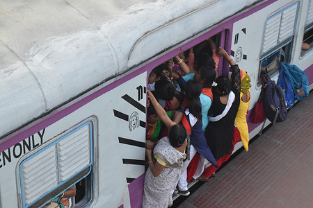 Commuters are traveling in a train at a railway station in Kolkata.