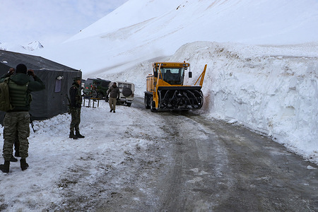 Workers from Border Roads Organisation (BRO) use a machine to clear a snow covered road near Himalayan Zoji La Pass after 68 days of closure due to harsh winter conditions, the pass was cleared and made safe for travel once again, allowing vehicles to traverse the stunning 3,528-meter-high mountain pass.