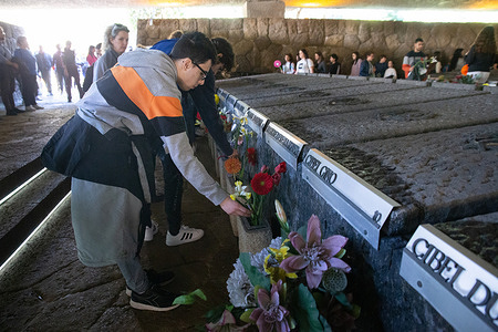 Students leave flowers on the tombs of the martyrs of the Fosse Ardeatine. Around 800 students in Rome took part in demonstration from Garbatella district to Fosse Ardeatine Shrine to remember and pay homage to the 335 people killed by Nazi-fascists at Fosse Ardeatine on 24 March 1944.