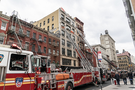 Rescue operation by firefighters to extinguish 2-alarm fire on commercial building on Grand street in Manhattan.