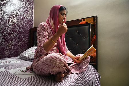 Indian woman offers evening prayers in the holy days of the Navratri. Hindus celeberate Navratri in commemoration of the goddesses Ambika and Durga