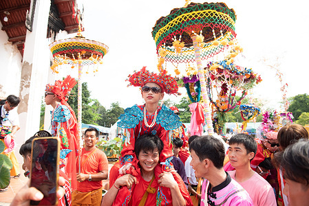 People join the novice parade as "poi sang long", a ceremony practised by Tai Yai people, at Wat Prasat (Prasat Temple), located in Nonthaburi province, 20 kilometers north of Bangkok, Thailand. The boys are dressed in elaborate costumes, on March 26, 2023.