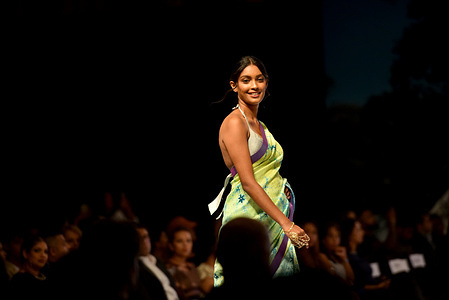 A model poses creation by fashion designer Buddhi Batiks during the 20th Colombo Fashion Week in Colombo