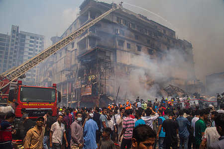 Firefighters, rescue workers, and local people work to extinguish a fire that broke out in the popular clothing place for cheaper clothes in Dhaka, Bangladesh, April 4,2023.