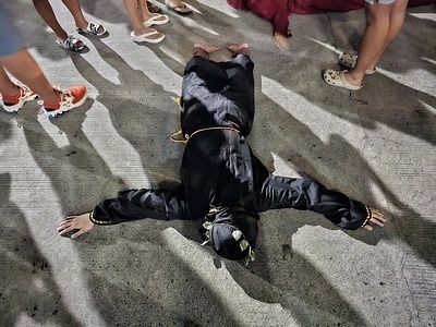Hooded man in black robe performs the acts of penitence during the observance of Maundy Thursday in San Fernando, Pampanga.