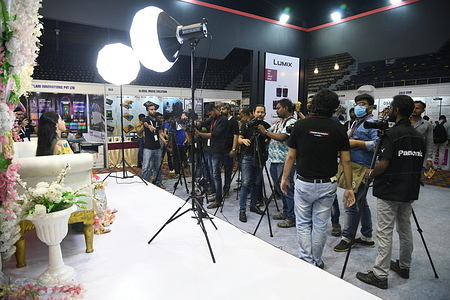 A model poses at the Phototech India 2023 - a photo & videography trade show on the first day of three days duration that organized by a private agency.