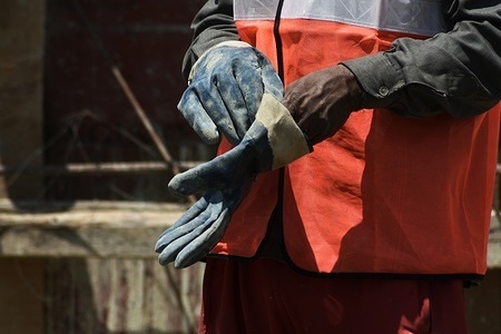Non-Kashmiri laborer removes gloves at a construction site on the day of International Labor Day. International Labor Day, also known as May Day, is marked across the world on May 1.