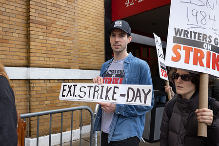 Writers Guild of America members march on a picket line in front of Silvercup Studios. After contract negotiations failed, thousands of unionized writers voted unanimously to strike, bringing television production to a halt, and initiating the first walkout in 15 years.