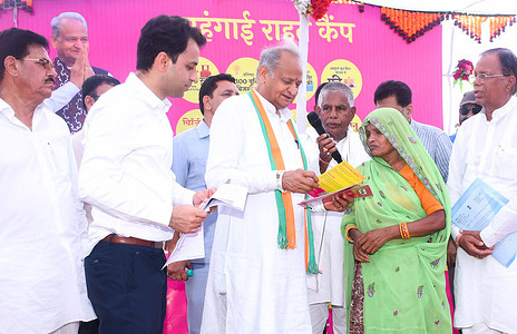 Rajasthan Chief Minister Ashok Gehlot interacts with a beneficiary during Inflation Relief Camp organised by congress government in Chittorgarh.