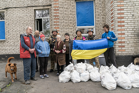 Members of police, volunteer of World Central Kitchen and dwellers of village of Velyka Novosilka of Donetsk region of Ukraine pose after receiving food